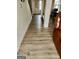 Bright hallway with light wood-look flooring, showing access to the living room and stairs at 2408 Centenary Way Ct, Dacula, GA 30019