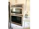 Stainless steel double oven and microwave combo, built into white cabinets at 1420 Donnelly Ave, Atlanta, GA 30310