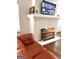 Living room with a brick fireplace and a large flat-screen TV at 1420 Donnelly Ave, Atlanta, GA 30310