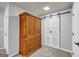 Finished basement area with a large wooden wardrobe and barn doors at 3252 Clairmont North Ne, Brookhaven, GA 30329