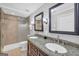 Bathroom featuring double sink vanity with granite countertop and tiled shower with glass enclosure at 3252 Clairmont North Ne, Brookhaven, GA 30329