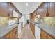 Modern kitchen with wood cabinets, granite counters, and stainless steel appliances at 3252 Clairmont North Ne, Brookhaven, GA 30329