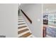 Wooden staircase with white risers and a view into the living room at 3252 Clairmont North Ne, Brookhaven, GA 30329