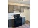 Modern kitchen featuring stainless steel appliances, gray cabinetry, and stylish countertops at 415 Dove Ln, Social Circle, GA 30025