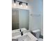 Bathroom featuring a white vanity with light and black faucet and a shower-tub combination at 415 Dove Ln, Social Circle, GA 30025