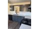 Modern kitchen featuring new countertops, black appliances, and gray cabinetry at 415 Dove Ln, Social Circle, GA 30025