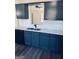 Modern kitchen showcasing sleek countertops, gray cabinets, and stainless steel appliances at 415 Dove Ln, Social Circle, GA 30025