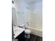 Bright bathroom featuring a white vanity with dark cabinets and a shower-tub combination at 415 Dove Ln, Social Circle, GA 30025