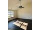 Spacious living room featuring vaulted ceilings, wood floors and a large window at 415 Dove Ln, Social Circle, GA 30025