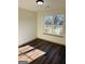 Bedroom with natural light, wood-look floors, and view of the outdoors from a double window at 415 Dove Ln, Social Circle, GA 30025