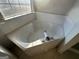 Corner bathtub with tile surround at 4010 Peachtree Farms Rd, Rex, GA 30273