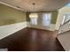 Formal dining room with hardwood floors and chandelier at 4010 Peachtree Farms Rd, Rex, GA 30273