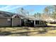 Home exterior showcasing a screened porch and yard at 65 Merideth Trce, Sharpsburg, GA 30277