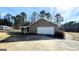 Attached garage with a large driveway at 65 Merideth Trce, Sharpsburg, GA 30277