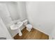 Well-maintained half-bath with a pedestal sink and modern fixtures at 1535 Valley Club Dr, Lawrenceville, GA 30044