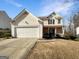 Charming two-story home with a brick facade and a two-car garage at 1535 Valley Club Dr, Lawrenceville, GA 30044