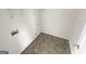 A clean laundry room featuring modern tile flooring and essential hookups at 1535 Valley Club Dr, Lawrenceville, GA 30044
