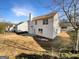 Exterior of the home displaying a well-kept lawn, a concrete patio, and pristine white siding at 1535 Valley Club Dr, Lawrenceville, GA 30044