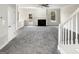 Spacious living room with a fireplace, carpet, and a staircase at 1535 Valley Club Dr, Lawrenceville, GA 30044