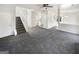 An open-concept living room features plush carpet and a staircase to the second floor at 1535 Valley Club Dr, Lawrenceville, GA 30044