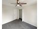 Comfortable bedroom with a ceiling fan and closet, complemented by gray carpet at 1535 Valley Club Dr, Lawrenceville, GA 30044