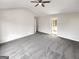 Spacious main bedroom featuring gray carpet, a ceiling fan, and an ensuite bathroom at 1535 Valley Club Dr, Lawrenceville, GA 30044