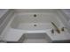 Relaxing bathroom with large bathtub and gold fixtures at 155 Carriage Gate Dr, Sharpsburg, GA 30277