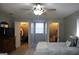 Bright bedroom featuring ample closet space and ceiling fan at 155 Carriage Gate Dr, Sharpsburg, GA 30277