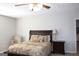 Primary bedroom with ceiling fan and nightstands at 155 Carriage Gate Dr, Sharpsburg, GA 30277