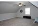 Spacious bonus room with large window and ceiling fan at 155 Carriage Gate Dr, Sharpsburg, GA 30277