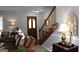 Inviting entryway with a wooden door and staircase at 155 Carriage Gate Dr, Sharpsburg, GA 30277