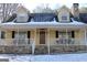 House exterior showcasing a charming front porch at 155 Carriage Gate Dr, Sharpsburg, GA 30277