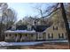 Two-story house with a wraparound porch and stone accents at 155 Carriage Gate Dr, Sharpsburg, GA 30277
