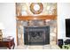 Stone fireplace with a wood mantel and hearth at 155 Carriage Gate Dr, Sharpsburg, GA 30277