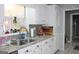 Kitchen features double sink, granite counters and white cabinets at 155 Carriage Gate Dr, Sharpsburg, GA 30277