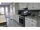 Bright kitchen with granite countertops and stainless steel appliances at 155 Carriage Gate Dr, Sharpsburg, GA 30277