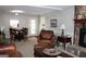 Open living area with a fireplace and leather furniture at 155 Carriage Gate Dr, Sharpsburg, GA 30277