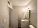 Clean bathroom with granite countertop, single sink, and mirrored medicine cabinet at 6595 Bellburn Rd, Atlanta, GA 30349