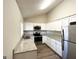 Modern kitchen featuring white cabinets, granite counters, and stainless steel appliances at 6595 Bellburn Rd, Atlanta, GA 30349