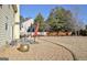 Spacious backyard features gravel, patio, grass area, privacy fence and mature trees at 704 Pine Grove Cir, Peachtree City, GA 30269