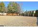 Large, open backyard with privacy fence and manicured shrubs at 704 Pine Grove Cir, Peachtree City, GA 30269