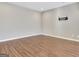 Empty basement space with laminate flooring and mounted television bracket at 704 Pine Grove Cir, Peachtree City, GA 30269
