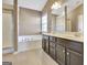 A bathroom featuring a shower, a tub, and a double sink at 704 Pine Grove Cir, Peachtree City, GA 30269