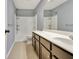 Bathroom featuring a tiled floor, vanity with a white countertop, and a shower with a showerhead at 704 Pine Grove Cir, Peachtree City, GA 30269