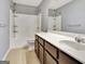 Bathroom featuring a tiled floor, vanity with a white countertop, and a shower with a showerhead at 704 Pine Grove Cir, Peachtree City, GA 30269