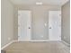 Neutral bedroom featuring two white doors and plush carpeting at 704 Pine Grove Cir, Peachtree City, GA 30269