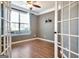 Versatile room featuring hardwood floors, window, and french door access, perfect for an office at 704 Pine Grove Cir, Peachtree City, GA 30269