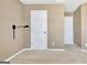 Bedroom with neutral walls, carpeting, and two white doors at 704 Pine Grove Cir, Peachtree City, GA 30269