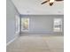Spacious carpeted bedroom with natural light from three windows at 704 Pine Grove Cir, Peachtree City, GA 30269