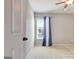 Bedroom featuring neutral walls, carpeting, ceiling fan, and a window with blue and white curtains at 704 Pine Grove Cir, Peachtree City, GA 30269